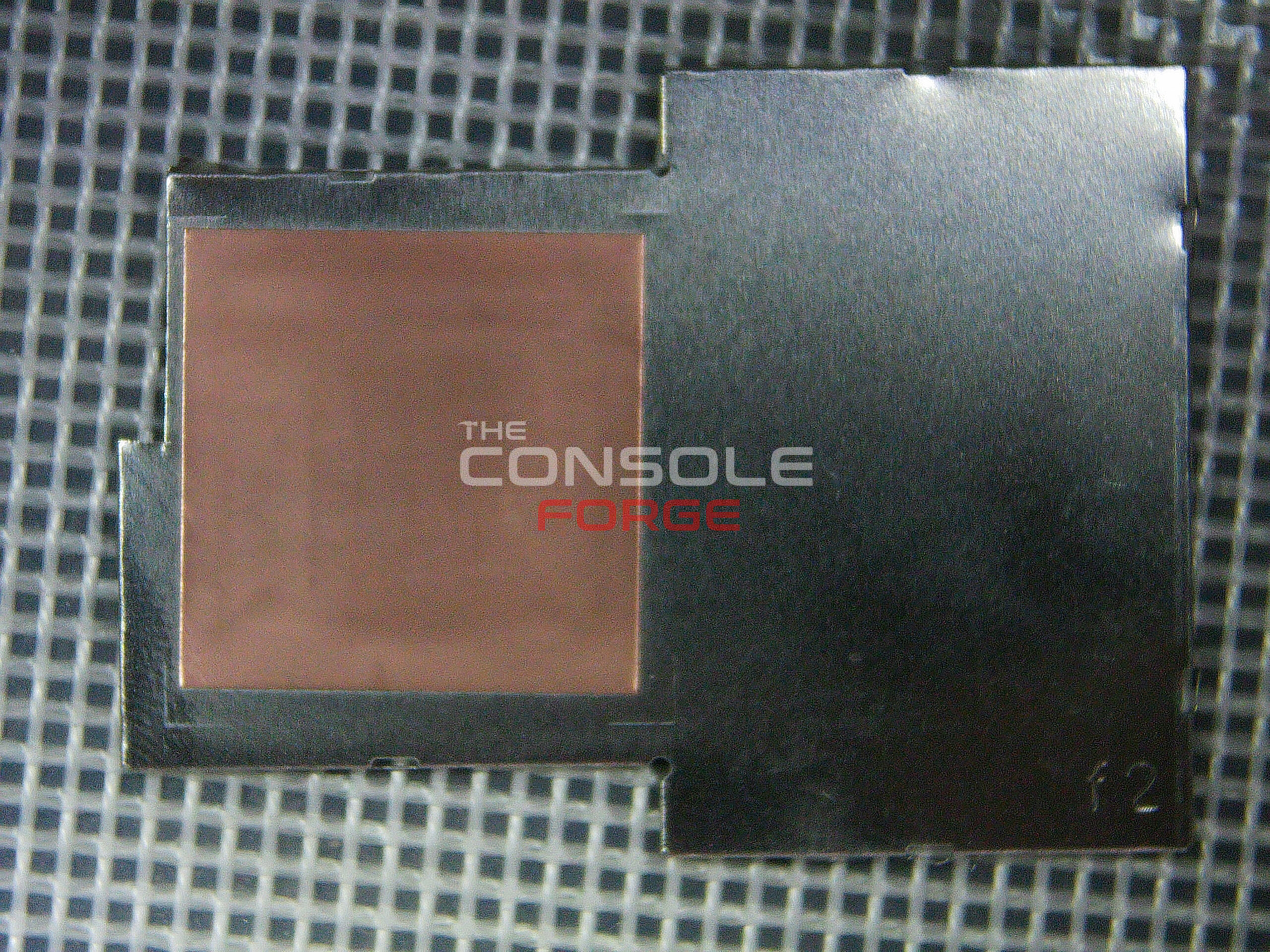 Nintendo Switch Lite IHS shield trimmed to create clearance for the RP2040 modchip flex cable.